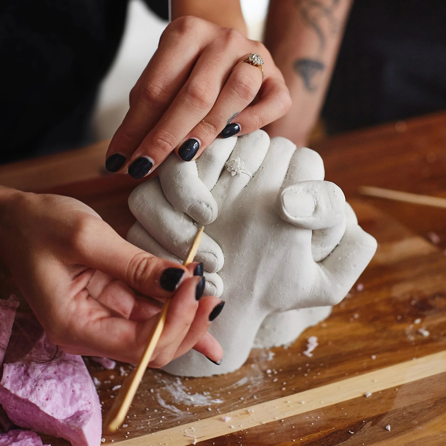 Couple molding hands together during the casting process